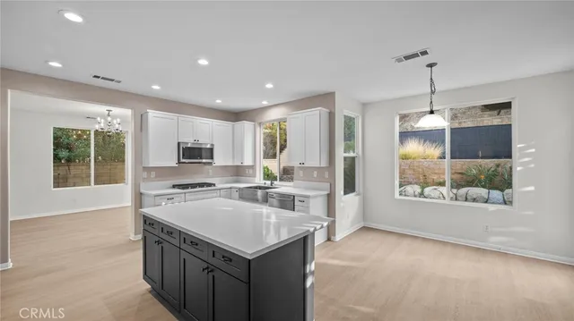 a kitchen with a stove a refrigerator and a sink