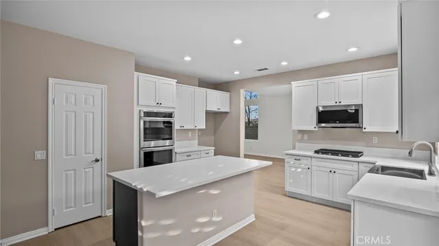 a kitchen with cabinets and stainless steel appliances