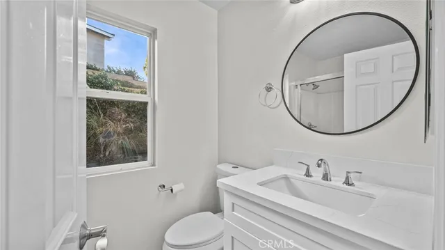 a white toilet sitting next to a bathroom sink