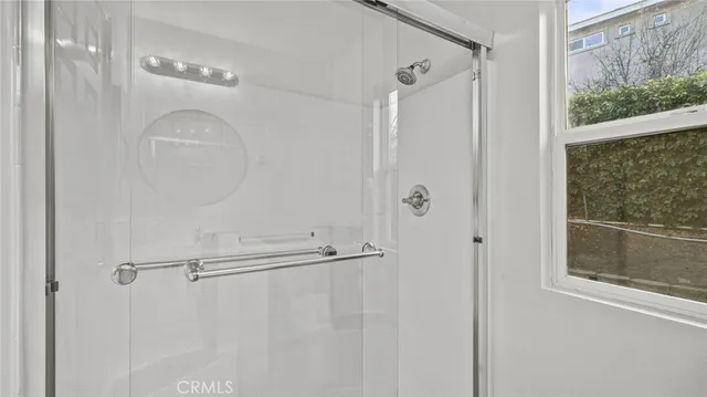 a bathroom with a glass shower door