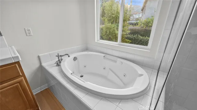 a bathroom with a bathtub and window