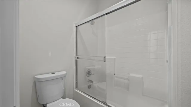 a bathroom with a shower and toilet
