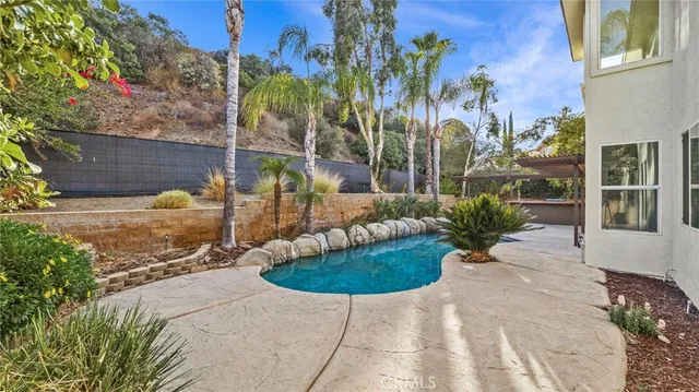 a view of a house with backyard and sitting area
