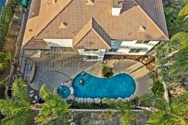 an aerial view of a house with garden space and street view