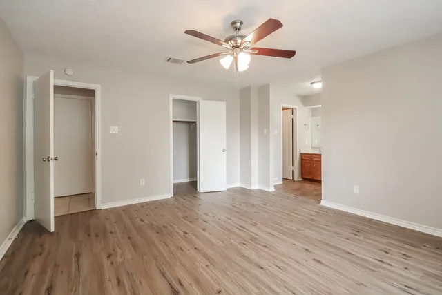 a view of an empty room with wooden floor