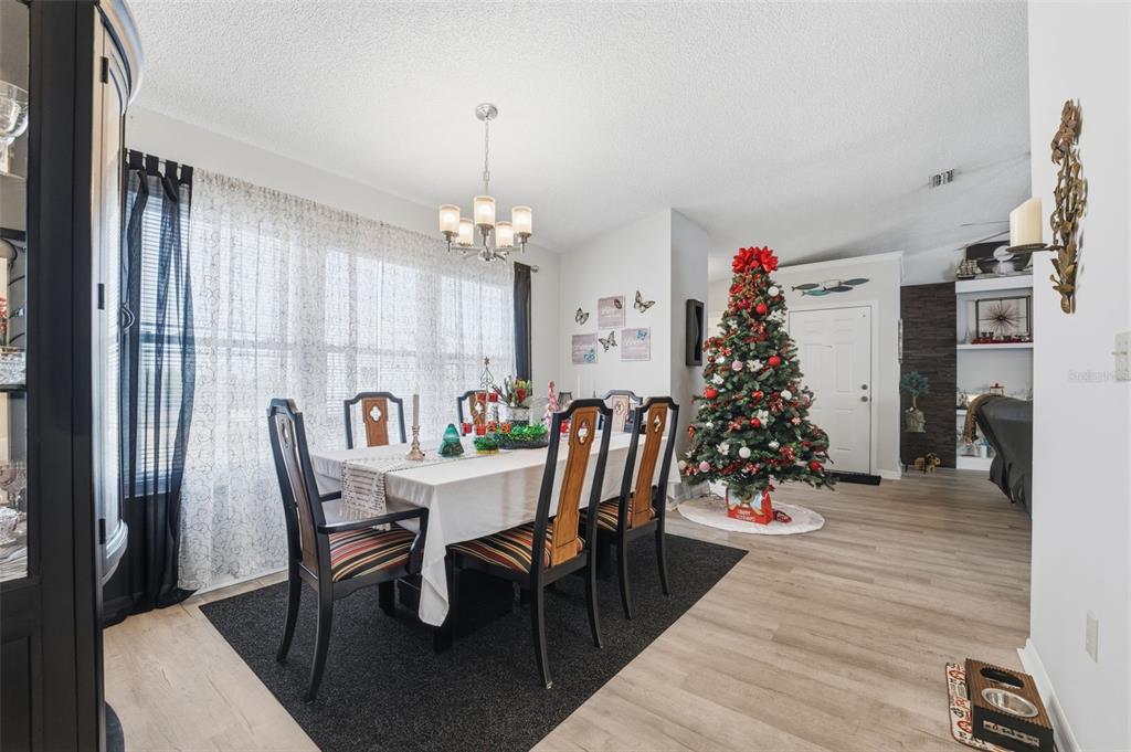3366 Bluefish Drive Hernando Beach, FL 34607 - Photo 11 of 75 a view of a dining room with furniture and chandelier