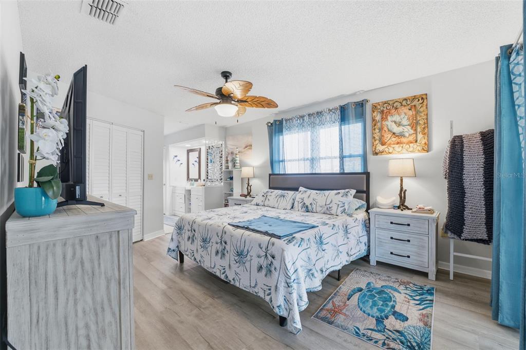 3366 Bluefish Drive Hernando Beach, FL 34607 - Photo 14 of 75 a bedroom with a bed and a chandelier