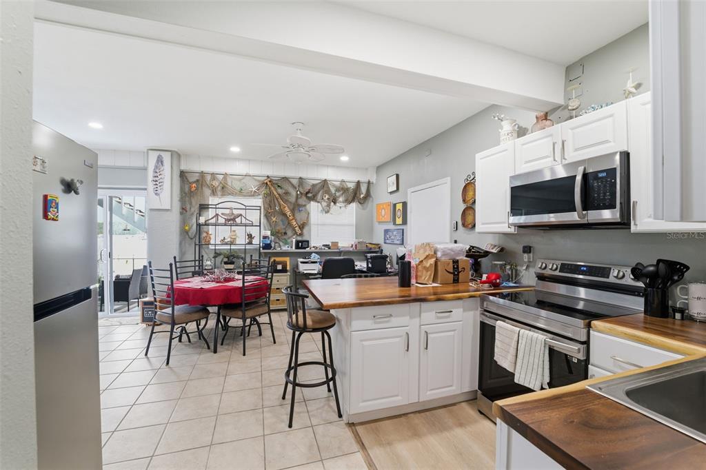 3366 Bluefish Drive Hernando Beach, FL 34607 - Photo 24 of 75 a kitchen with stainless steel appliances kitchen island granite countertop a sink a stove a dining table and chairs