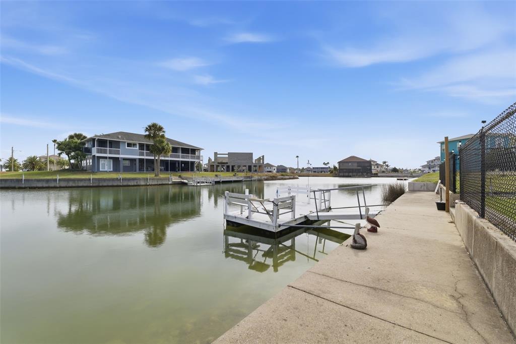 3366 Bluefish Drive Hernando Beach, FL 34607 - Photo 30 of 75 a roof deck with table and chairs a barbeque