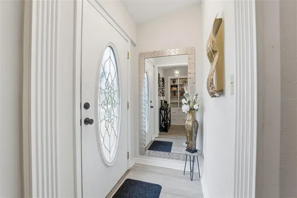 a view of a hallway with a livingroom and furniture