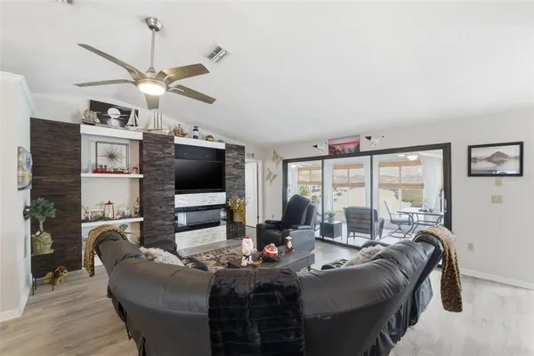 a living room with furniture and a chandelier