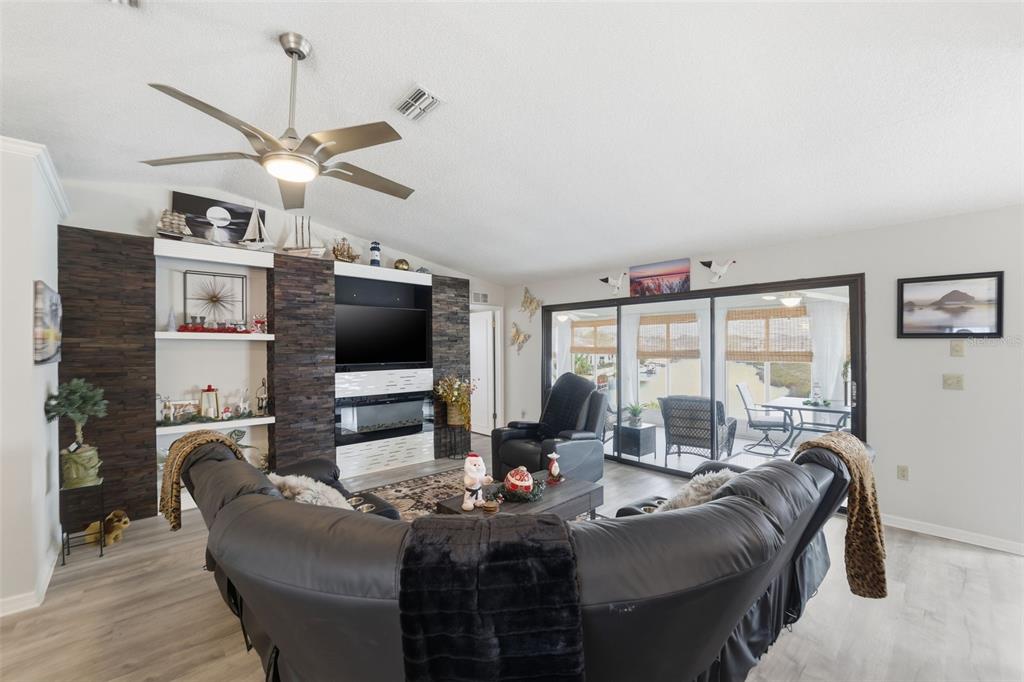 3366 Bluefish Drive Hernando Beach, FL 34607 - Photo 5 of 75 a living room with furniture a flat screen tv and a large window