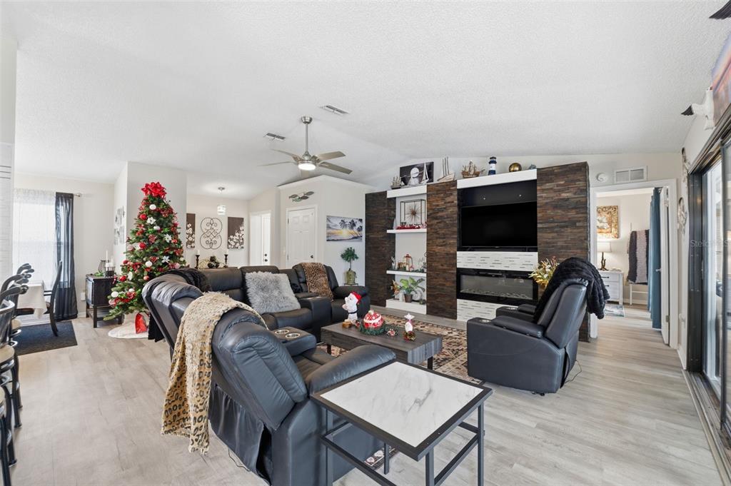 3366 Bluefish Drive Hernando Beach, FL 34607 - Photo 61 of 75 a living room with furniture a flat screen tv and kitchen view