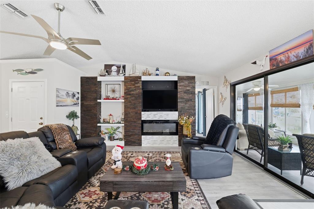 3366 Bluefish Drive Hernando Beach, FL 34607 - Photo 62 of 75 a living room with furniture fireplace and flat screen tv