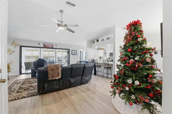 a kitchen with stainless steel appliances a sink a stove a refrigerator cabinets and a dining table