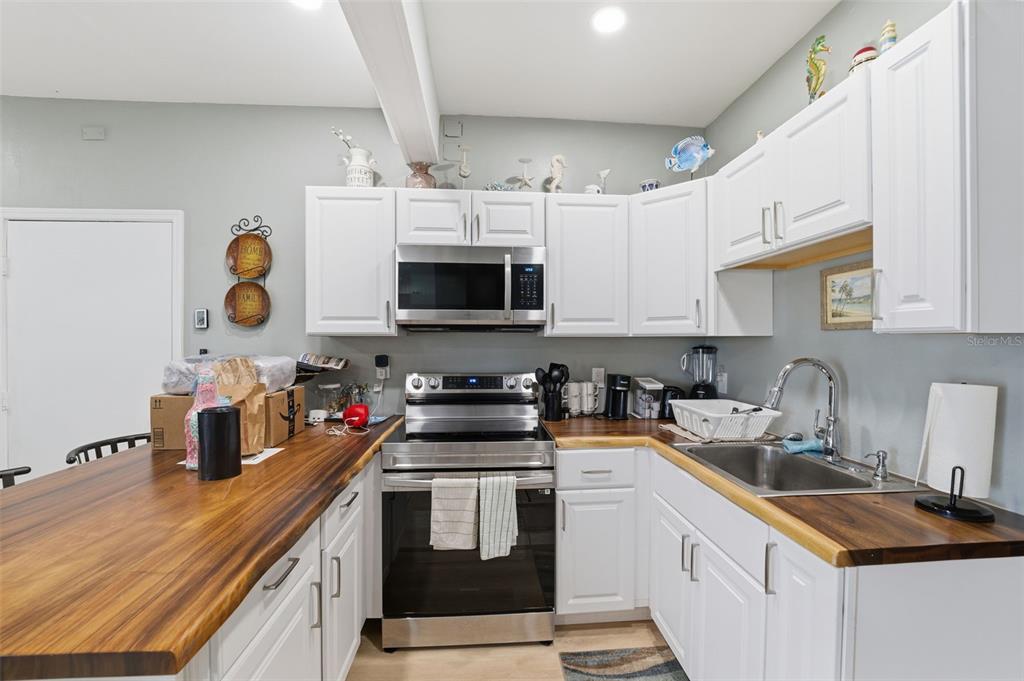 3366 Bluefish Drive Hernando Beach, FL 34607 - Photo 74 of 75 a kitchen with stainless steel appliances granite countertop a sink a stove a microwave and cabinets