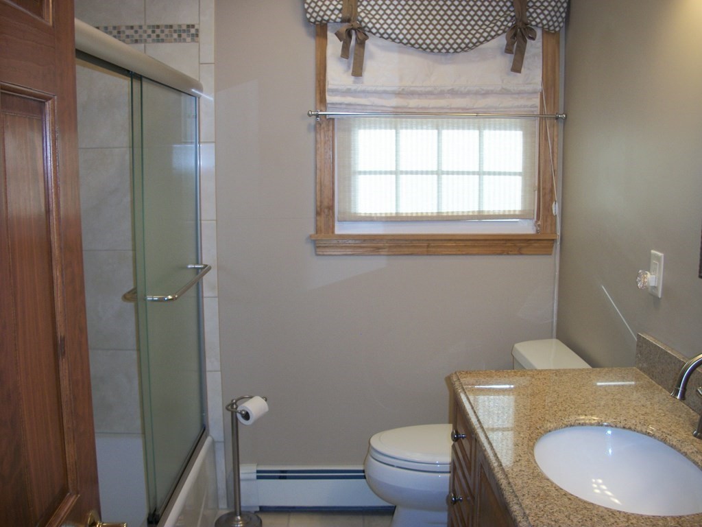 3 Juniper Lane Rutland, MA 01543 - Photo 11 of 17 a bathroom with a granite countertop toilet a sink and a mirror