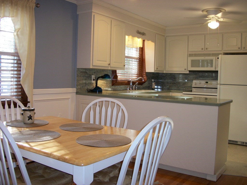 3 Juniper Lane Rutland, MA 01543 - Photo 6 of 17 a kitchen with a sink a stove a dining table and chairs