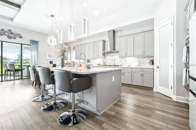 a view of kitchen with granite countertop cabinets a sink and stainless steel appliances