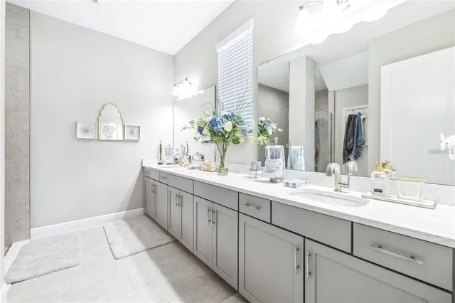 a spacious bathroom with a double vanity sink and a mirror