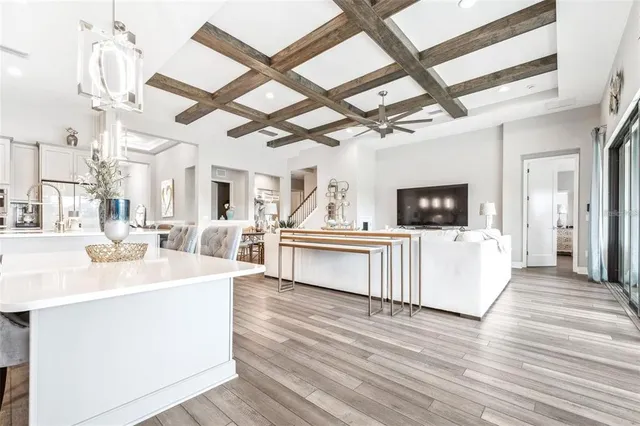 a view of living room kitchen with stainless steel appliances kitchen island