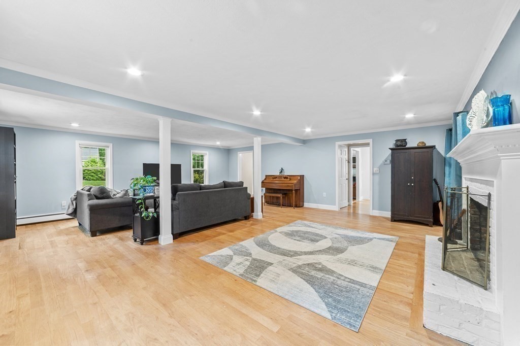 21 Olde Lantern Road Acton, MA 01720 - Photo 11 of 41 a large bedroom with furniture fireplace and flat screen tv