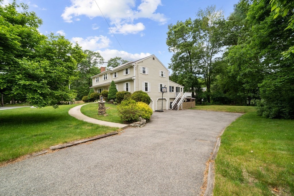 21 Olde Lantern Road Acton, MA 01720 - Photo 2 of 41 a front view of a house with garden