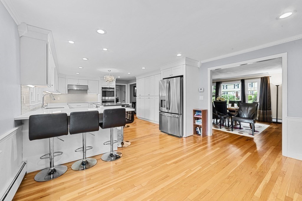 21 Olde Lantern Road Acton, MA 01720 - Photo 6 of 41 a kitchen with stainless steel appliances kitchen island granite countertop a refrigerator and cabinets