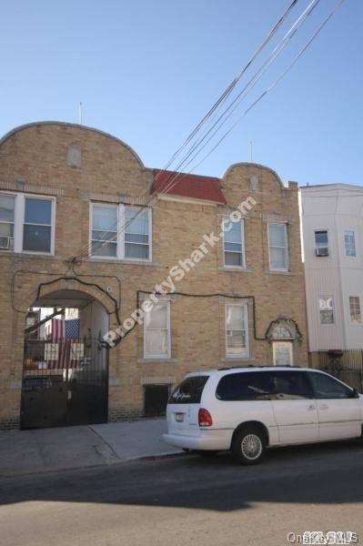 a front view of a house with parking area
