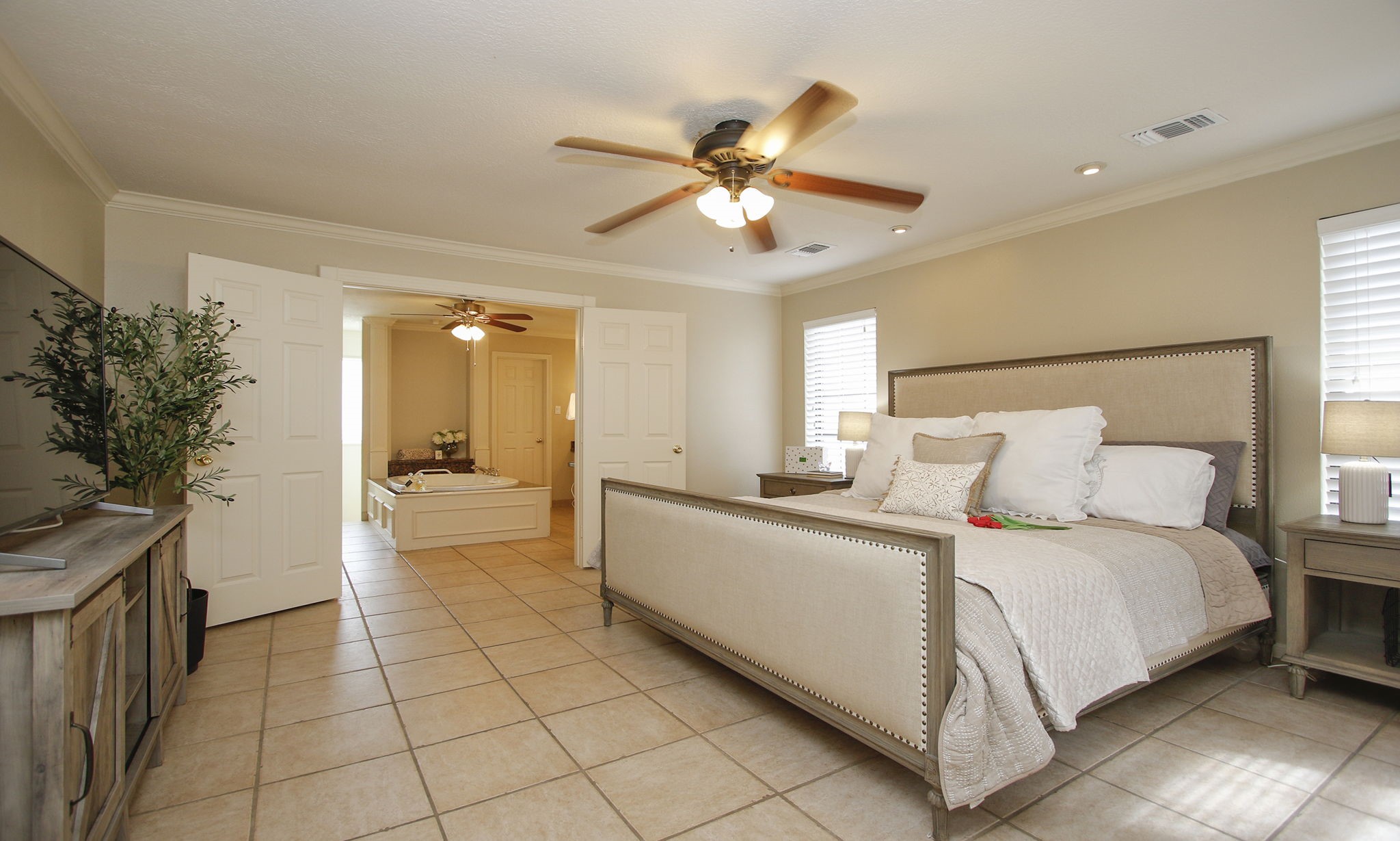 16114 Kempton Park Drive Spring, TX 77379 - Photo 23 of 46 PRIMARY BEDROOM - The bedroom is located off the den and features tile floors and ceiling fan.