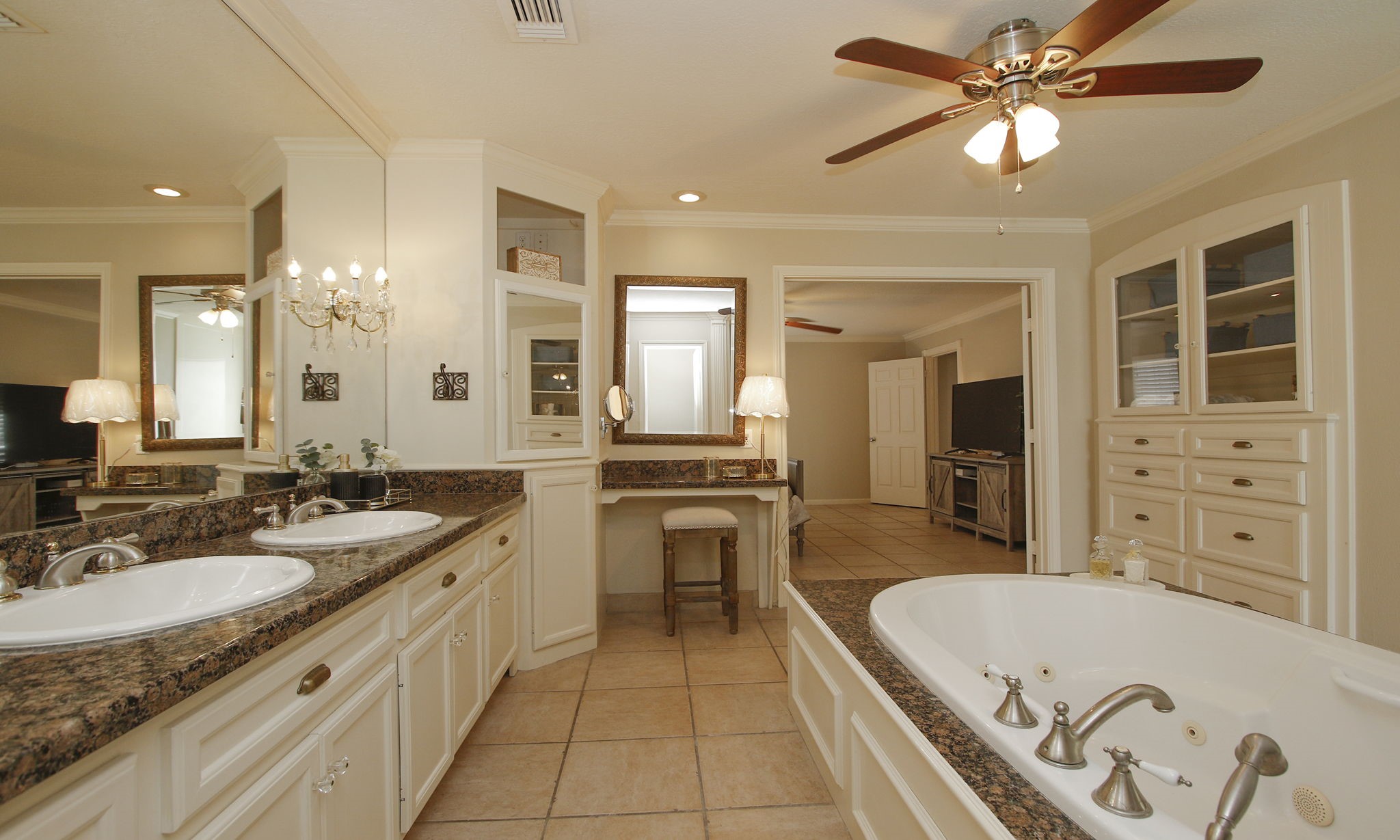 16114 Kempton Park Drive Spring, TX 77379 - Photo 25 of 46 PRIMARY BATHROOM STORAGE - The bathroom features double sinks, glass front cabinets, custom drawers, and a large walk in closet.