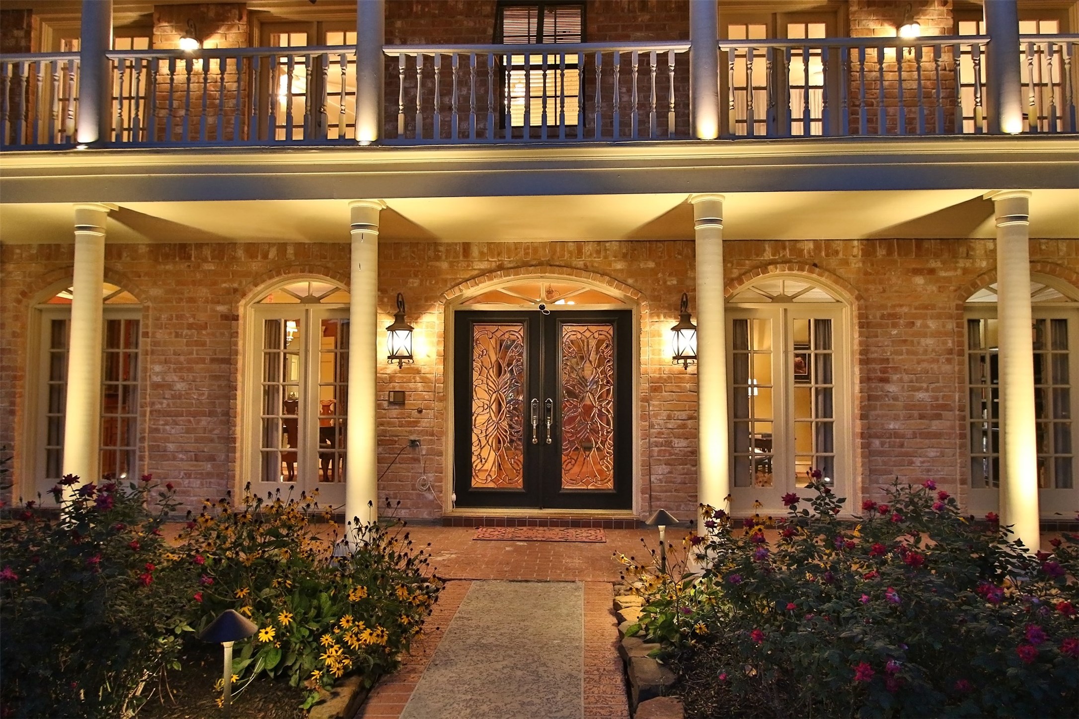 16114 Kempton Park Drive Spring, TX 77379 - Photo 4 of 46 GRACEFUL BRICK ARCHES FRAME THE TOP
OF EACH WINDOW - The exterior architecture of
this home is filled with details including bead board
on the balcony ceiling, crown molding above the
second floor French doors and railing with
individually lighted statuesque columns.