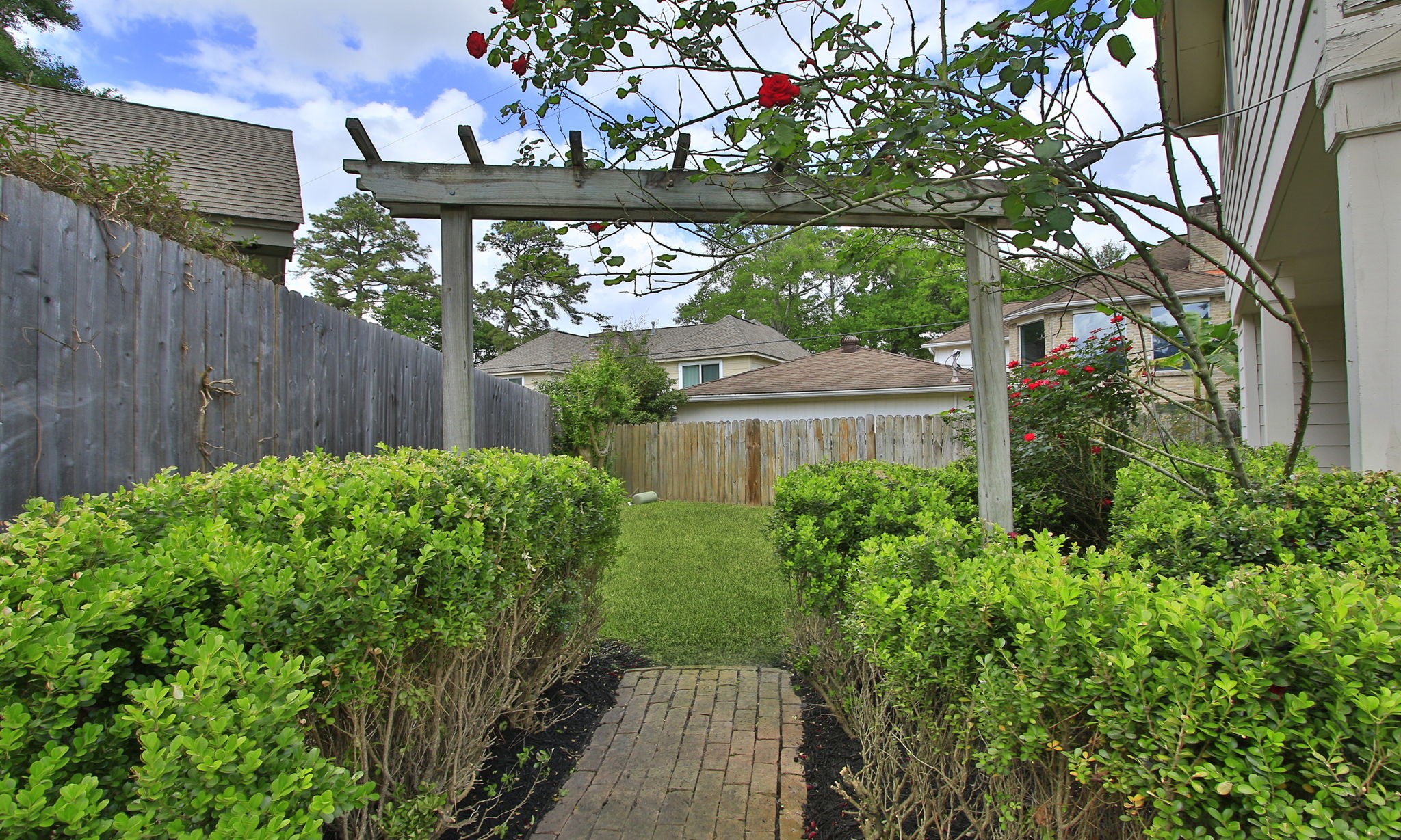 16114 Kempton Park Drive Spring, TX 77379 - Photo 44 of 46 CHARMING GARDEN AREA - To the left of the garage is this charming path to a grassy area perfect for a cafe table and chairs or hammock.