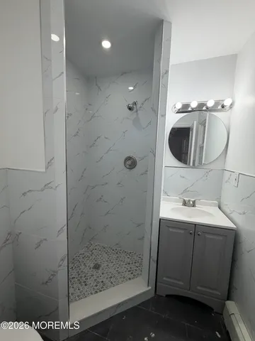 a bathroom with a sink a toilet and shower