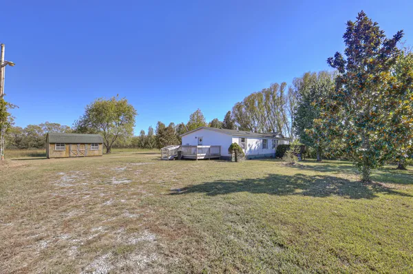 a pathway of a house with a yard