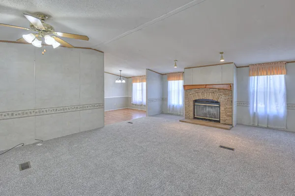 a view of empty room with a fireplace