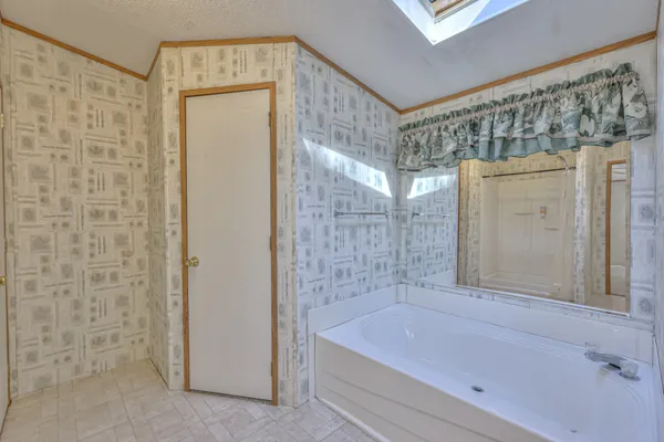 a bathroom with a bathtub and shower