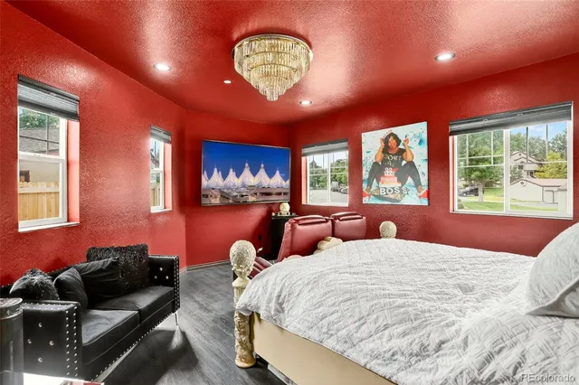 a bedroom with a large bed and a large window