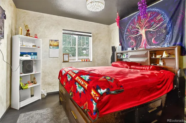 a bed sitting in a bedroom next to a window