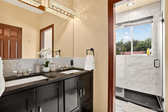 a bathroom with a double vanity sink and a mirror