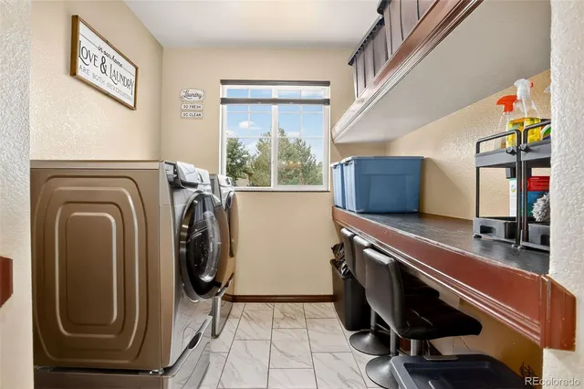a utility room with sink dryer and washer