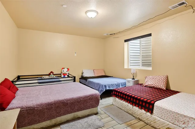 a bedroom with two beds and a chandelier