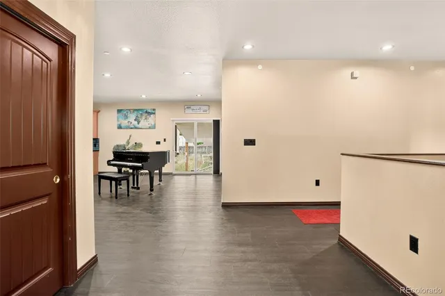 an empty room with wooden floor and furniture