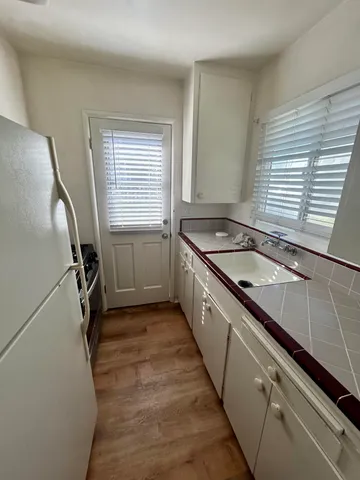 a kitchen with a sink stove and cabinets