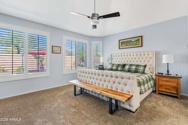 a bed sitting in a bedroom next to a window
