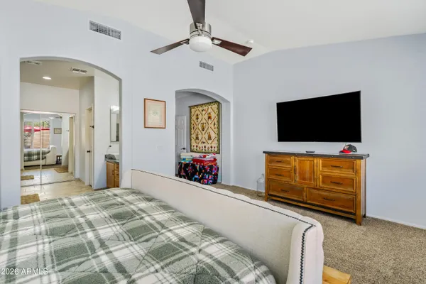 a bedroom with furniture and flat screen tv