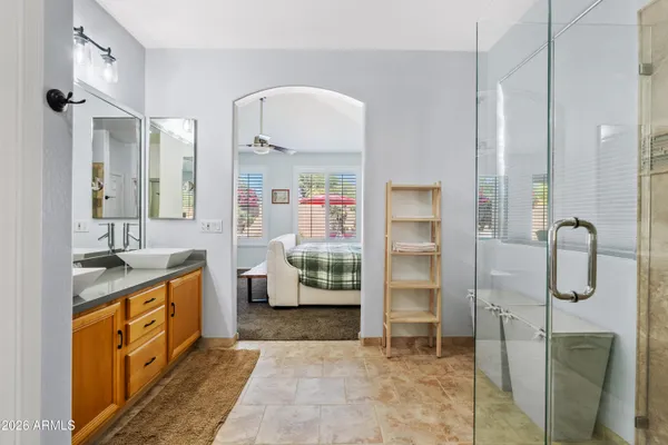 a spacious bathroom with a tub sink and mirror