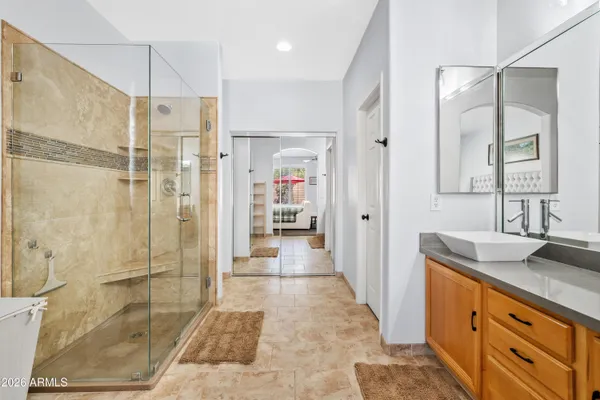 a bathroom with a granite countertop sink a shower and a mirror