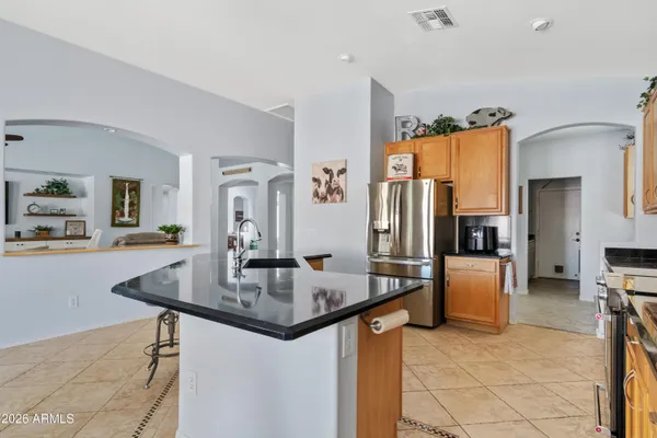a kitchen with stainless steel appliances granite countertop a sink refrigerator and microwave