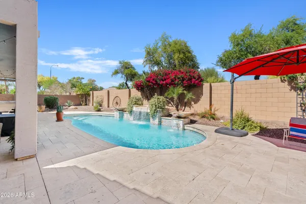 a view of a house with backyard and sitting area